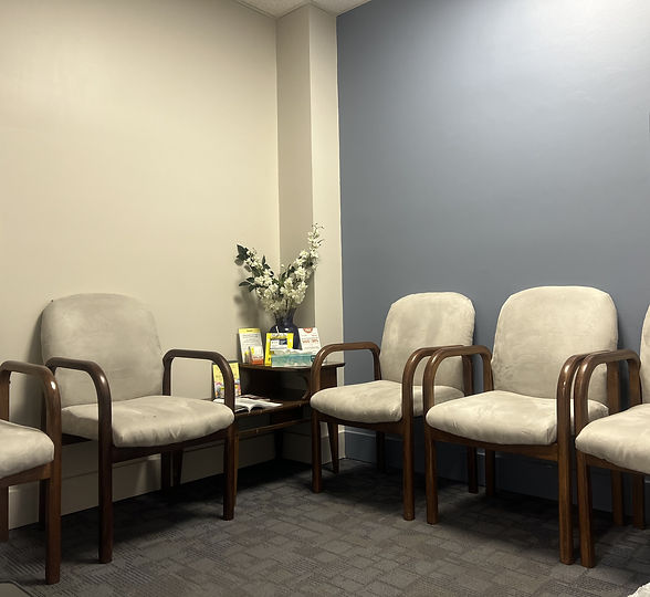 The waiting room at Blanton-Peale, with upholstered chairs and a table of flowers.